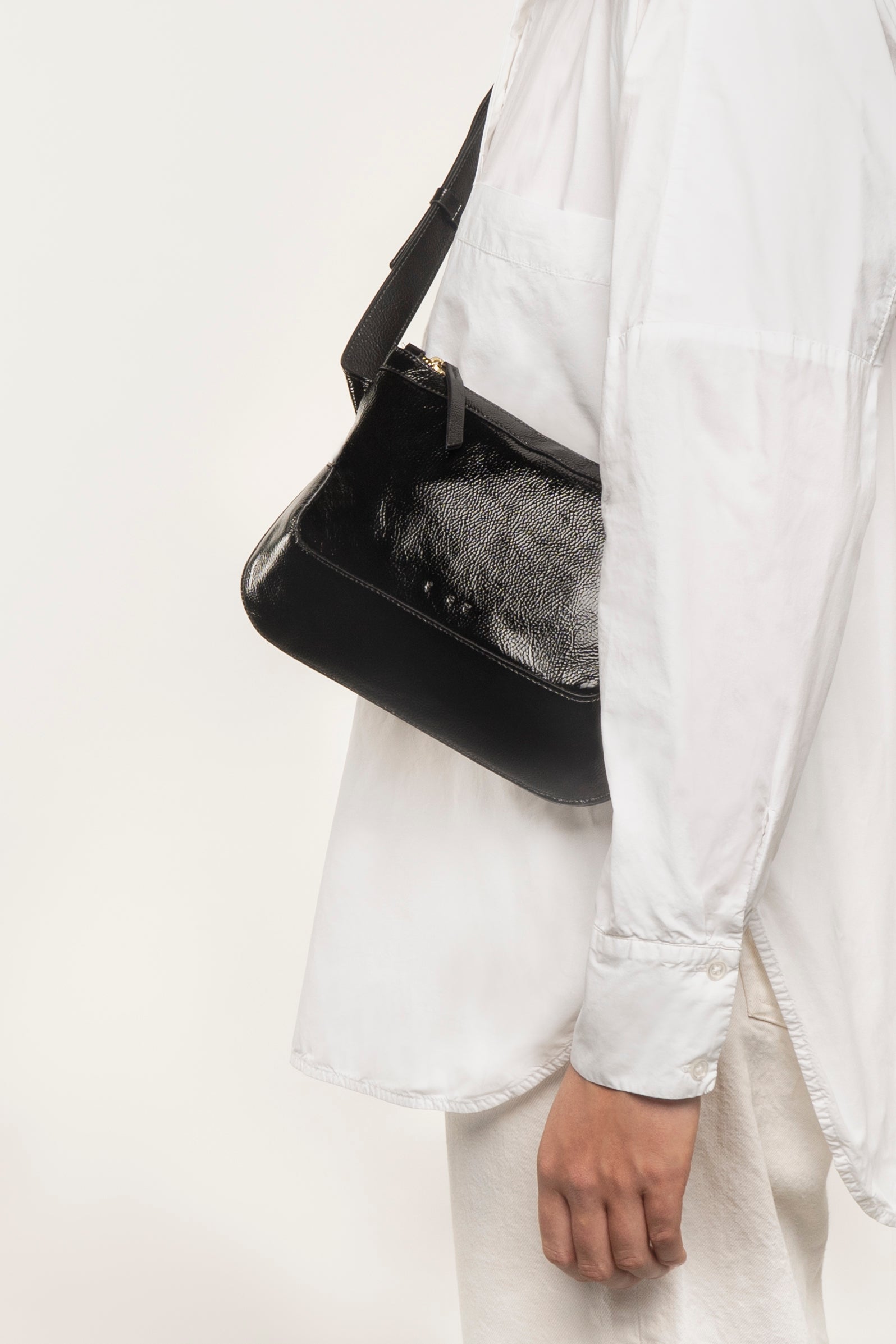 the festival glossy black crossbody bag