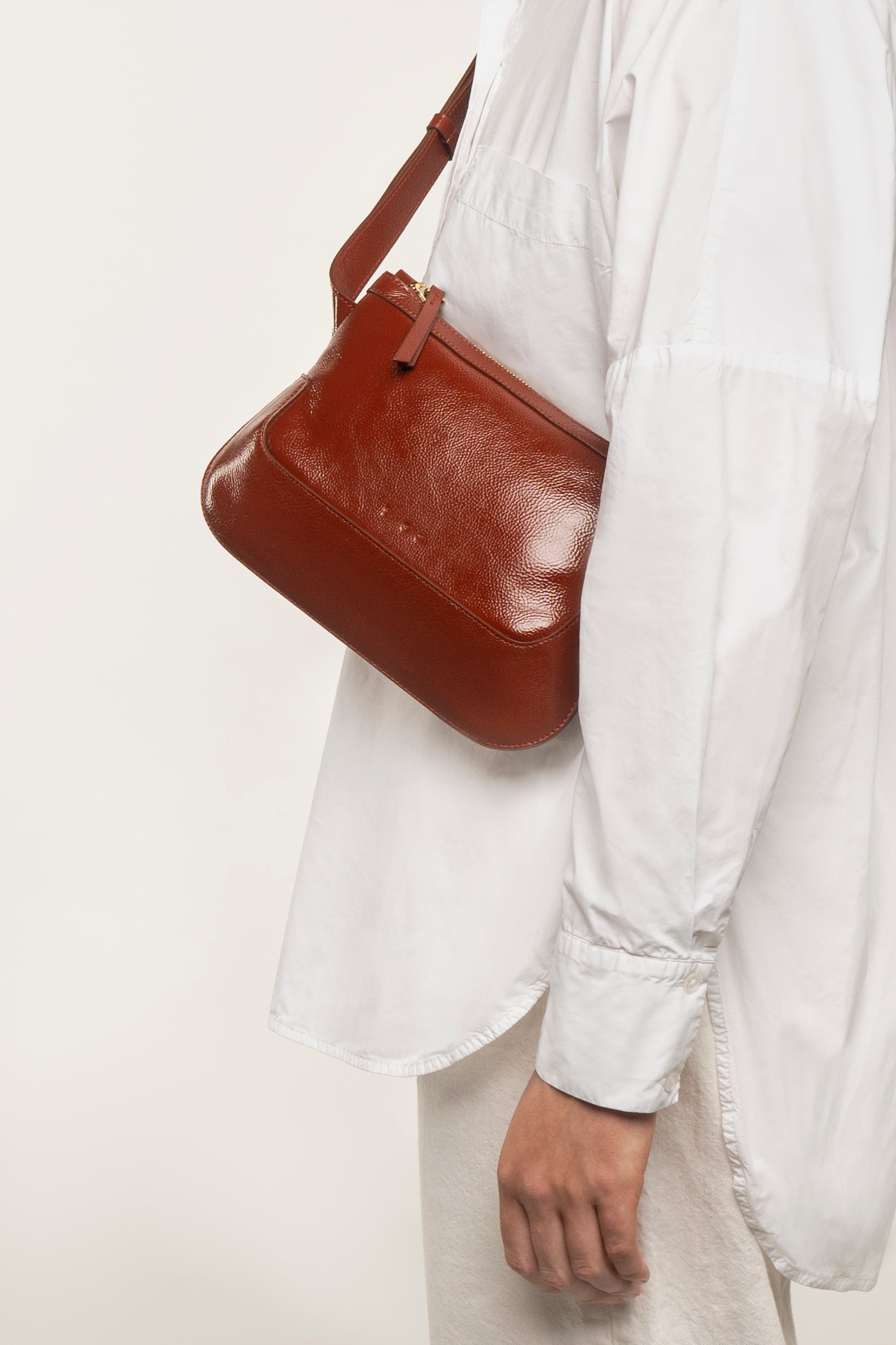 the festival glossy brunette crossbody bag